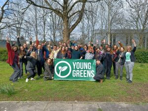 30 Under 30 2022 30 Under 30 Graduates from 2022 holding the Young Greens banner with their fists raised