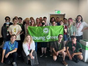 Young Greens Convention 2022 Group of Young Greens at Convention 2022. They're holding the Young Greens banner and are all smiling.