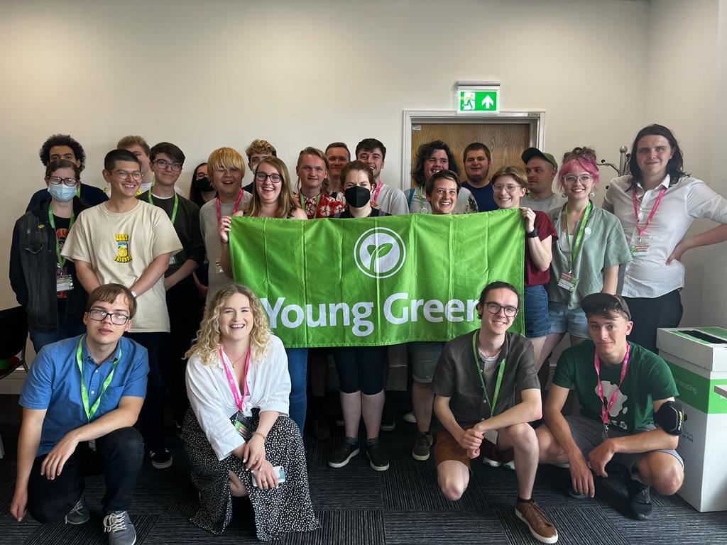 Young Greens Convention 2022 Group of Young Greens at Convention 2022. They're holding the Young Greens banner and are all smiling.